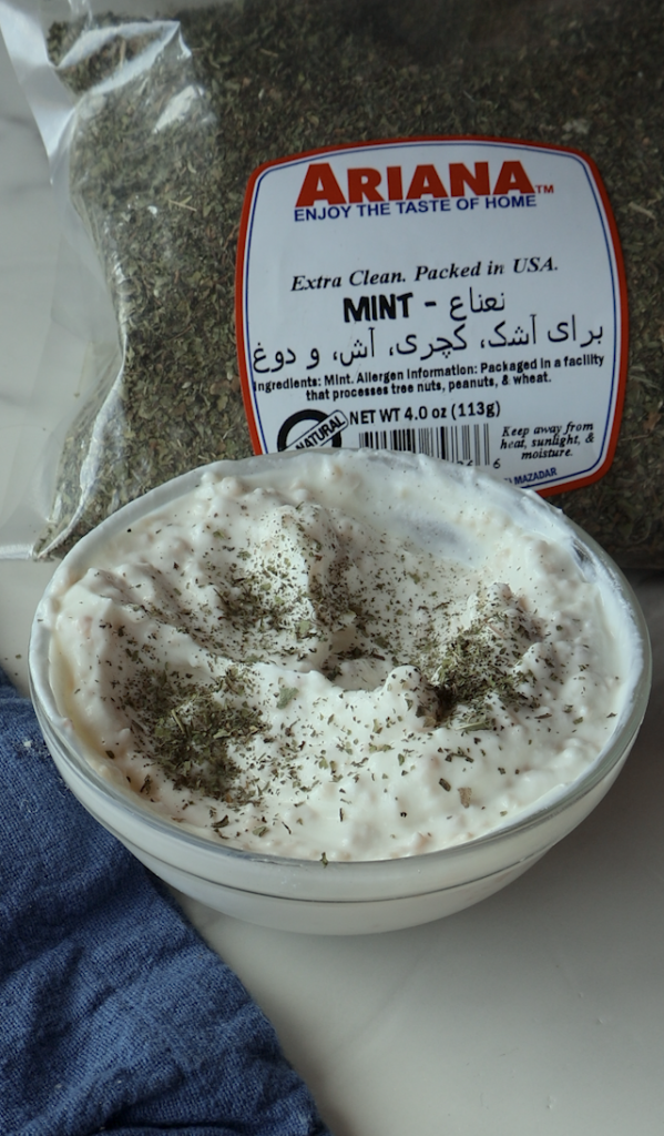 a garlicky yogurt mix with dried mint over it